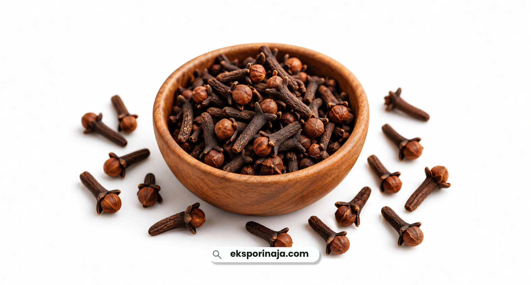 Dried cloves in a wooden bowl with whole cloves scattered around on a clean white background